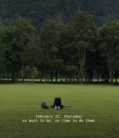 a person laying on the ground in a field with trees behind them and a quote written below