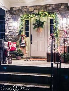 a front porch decorated for christmas with wreaths and lights