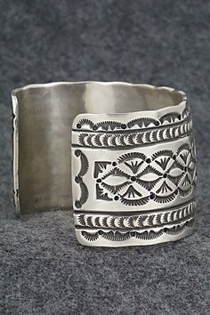 This stunning sterling silver bracelet was made by Navajo silversmith Leonard Maloney. The back is signed Maloney and stamped sterling.Size: 6" (will fit up to a 6 3/8" wrist)Gap: 1 3/8"Width: 1 3/4"Free shipping on all orders! We ship with USPS and always include tracking. All orders ship within a day of payment.Returns are accepted up to 30 days after you receive your order. Just send us a message. Our shop offers cash back or store credit. The item must be returned in new condition. Southwestern Silver Cuff Bracelet, Southwestern Engraved Sterling Silver Bracelet Gift, Engraved Sterling Silver Bracelet Gift, Untreated Sterling Silver Bracelet, Engraved Sterling Silver Bohemian Bracelet, Bohemian Etched Sterling Silver Bracelets, Silver Artisan Bracelet, Bohemian Sterling Silver Engraved Bracelet, Stamped Sterling Silver Bohemian Cuff Bracelet