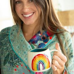 Cup Of Happy. Rainbows make everyone happy! And you'll smile when you see this cheerful, hand-sculpted Rainbow Mug. Give a mug that will delight anyone and be someone’s happy today!   Please note: Intentionally has an uneven edge for artistic cuteness and hand sculpted nature.  14 oz. Ceramic. 3.6" x 4". Dishwasher And Microwave Safe. Boho Socks, Bed Roll, Blanket Patchwork, Rainbow Mug, Lounge Bed, Rainbow Coffee, Friends Coffee Mug, Dish Rag, Ceramic Tumbler