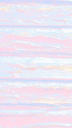 a blurry image of the sky and water in pink, white and blue colors