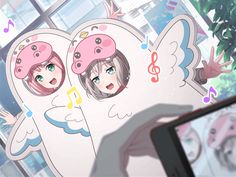 two girls with pink hats and angel wings on their heads are looking at a cell phone