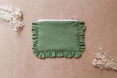 a small green pouch sitting on top of a table