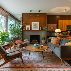 a living room filled with furniture and a fire place in the middle of a room