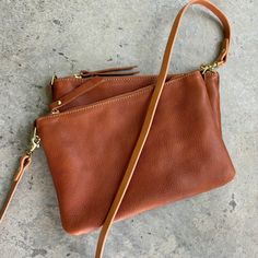 This is the perfect simple everyday leather crossbody bag sized for just the essentials! Slightly larger than our small clutch, and with a removable crossbody strap, this simple yet functional bag turns into an elegant evening clutch! It’s the perfect sightseeing travel bag for your next trip, as it securely zips closed, and easily holds your phone, passport, keys, small wallet, sunglasses, and a bit of makeup and can be worn across your body for hands free traveling. Its unfussy and minimalist Everyday Purse, Small Clutch, Gold Monogram, Crossbody Clutch, Day Bag, Evening Clutch, Small Wallet, Personalize Bag, Perfect Bag