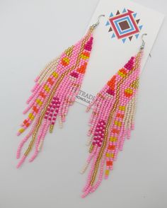 Great new design Native American Style Boho modern powwow earrings. Stainless steel posts with beads woven with traditional styles and with a great combination of colors. Nice medium long length for all necks and shapes. Perfect for matching your dancing regalia or to be worn on its own. All hand made and as always we Ship Free to your home or office. Pink Large Beads Dangle Earrings, Adjustable Pink Earrings With Large Beads, Pink Dangle Beaded Earrings With Large Beads, Pink Large Beaded Dangle Earrings, Pink Large Bead Dangle Earrings, Pink Dangle Earrings With Large Beads, Traditional Pink Beaded Earrings With Dangling Beads, Artisan Pink Earrings For Festival, Pink Bohemian Beads With Dangling Details