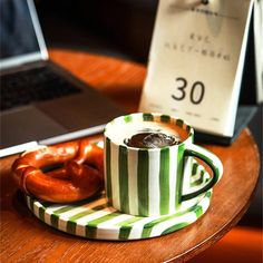 a cup of coffee and some pretzels on a table