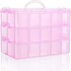 a pink plastic storage box filled with lots of clear drawers and dividers on top of a white surface