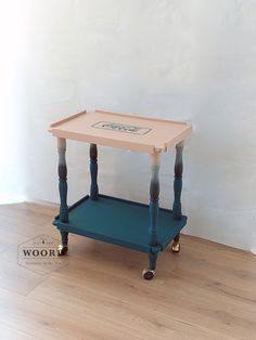 a small wooden table on wheels with the word hope painted on it's top