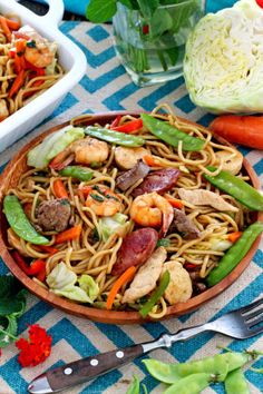 a close up of a plate of food on a table with carrots and cabbage