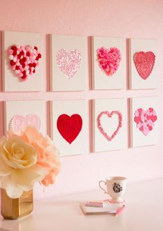 a white desk topped with lots of pink hearts