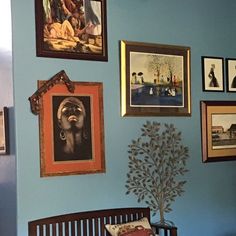 a blue wall with pictures on it and a baby crib