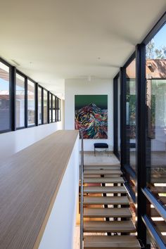 the stairs lead up to the second floor in this modern house with wood and glass railings