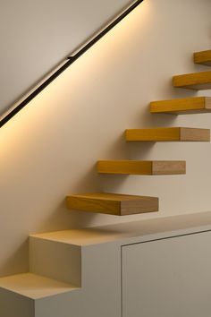 the stairs are made of wood and have lights on them