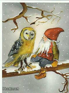 an owl and gnome sitting on a branch in the snow