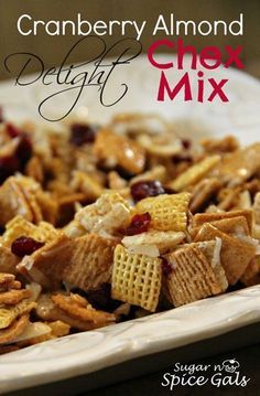 cranberry almond delight chex mix on a white plate with the title above it