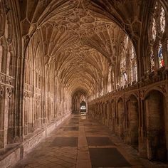 the inside of an old cathedral with stone floors and vaulted ceilings, along with stained glass windows