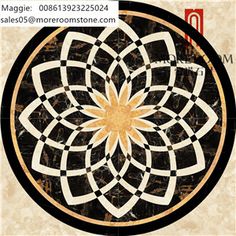 a black and white circular design with gold in the center on a marble floor tile