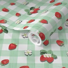 a green and white checkered table cloth with strawberries on it, all over