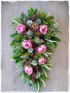 an overhead view of pink flowers and greenery