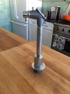 a faucet sitting on top of a wooden counter in a kitchen