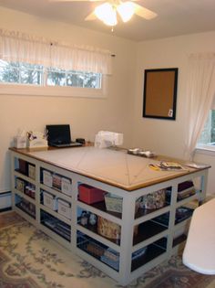 a room with a desk and shelves in it