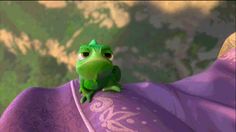 a green frog sitting on top of a purple cloth