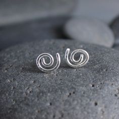 These adorable spiral stud earrings make the perfect gift for anyone with pierced ears. These earrings are perfect for a guy or a girl, anyone with multiple piercings, or just for everyday wear. They are quirky...They are fun! Here are the details about these earrings: The stud earrings are made from sterling silver wire and posts that are approximately 10mm in diameter. These earrings are NOT perfectly uniform...each pair is unique and not-quite-perfect spirals because they are handmade by me! Hypoallergenic Spiral Earrings For Everyday, Unique Swirl Earrings As Gift, Minimalist Spiral Earrings For Gifts, Minimalist Spiral Earrings As Gift, Unique Swirl Earrings For Gifts, Swirl-shaped Pierced Earrings For Gift, Minimalist Swirl Earrings As Gift, Minimalist Swirl Earrings Gift, Silver Spiral Cartilage Earrings As Gift