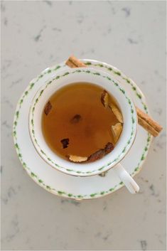 a cup of tea with cinnamon sticks in it