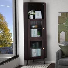 a tall wooden bookcase sitting next to a window