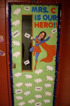 a door decorated with the words mrs c is our hero and a supergirl on it