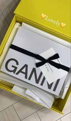 the box is open and has a black ribbon on it that says ganmi in large letters