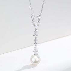 Freshwater Akoya Pearl & Cubic Zirconia Y-Shape Necklace Step into a world of refined elegance with our 10-11mm Freshwater Akoya Pearl Cubic Zirconia Pendant Necklace. This sophisticated Y-shaped chain is intricately adorned with precisely set cubic zirconia, leading to a stunning large freshwater Akoya pearl pendant. With a length of 40cm and an additional 5cm extension, this necklace provides a graceful drape that complements any neckline. Perfectly suited for evening gowns, bridal wear, or a Double Strand Pearl Necklace, Round Pearl Earrings, Large Pearl Earrings, Popular Necklaces, Pearl Strands Necklace, Golden South Sea Pearls, Pearl Jewelry Necklace, Cultured Pearl Necklace, Pearl Necklaces