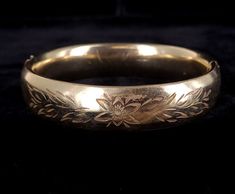 "Antique Gold Over Sterling Silver Victorian Floral Engraved Thick Bangle Bracelet 7\" Item offered is an antique Victorian gold over silver engraved bangle bracelet. This bracelet is stunning. There are floral designs engraved on the front. Piece is marked \"Sterling\". The clasp is a hinged clasp. Condition is good, with age related wear. There may be some discoloration to the gold. Please see photos as they are an extension of our written description. Measurement: Length: 7\" Width: .6\" Weig Fun Antique Gold Engraved Bangle Bracelet, Engraved Antique Gold Bangle Bracelet, Engraved Victorian Bracelets, Adjustable Engraved Victorian Bangle, Victorian Style Metal Bangle Bracelet, Victorian Engraved Gold Bangle Bracelet, Gold Filigree Victorian Bangle, Engraved Bangle Bracelet, Engraved Bangle