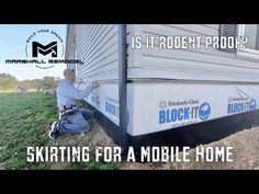 a man is fixing the side of a mobile home