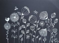 a chalkboard with flowers and birds drawn on it