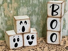 three wooden blocks with faces painted on them