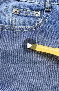 a yellow toothbrush sticking out of the back pocket of a pair of blue jeans