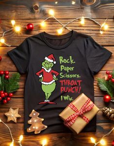 a black shirt that says rock paper scissors and throat punch with christmas decorations around it