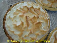 three pies sitting on top of a newspaper next to each other in plastic wrappers