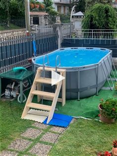 an above ground swimming pool with steps leading up to it and a ladder in the grass