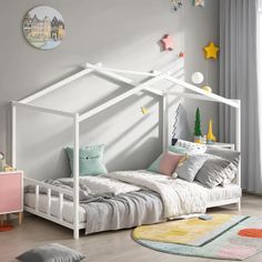 a child's bedroom with a white canopy bed