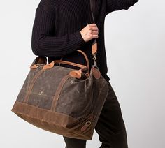 Crafted of waxed canvas with leather handles. 100% cotton lining. Water resistant exterior. Top zip closure. Features 1 inner zip pocket, 2 standard inner pockets, brass clip for removable shoulder strap and a 15" leather handle. Imported. Spot clean only. Brown Waxed Canvas Duffle Bag For Everyday, Travel Satchel With Waxed Canvas Finish, Brown Waxed Canvas Weekender Bag, Everyday Coated Canvas Travel Bag With Waxed Finish, Brown Waxed Canvas Bag With Zipper, Everyday Waxed Coated Canvas Travel Bag, Everyday Waxed Finish Coated Canvas Travel Bag, Brown Canvas Weekender Bag With Waxed Finish, Brown Waxed Canvas Weekender Bag With Canvas Lining