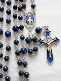 This lapis lazuli rosary can also be worn as a necklace. The body is about 27 inches and the cross extension is 6 inches. The blue enameled cross and connection were made in Italy and are oxidized silver. I used 6mm and 8mm lapis rounds and hand turned each of the wires myself. The crucifix is 1 and 3/4 inches long. This rosary will be slipped into an organza bag and shipped in a bubble mailer. Blue Spiritual Rosary With Gemstone Beads, Spiritual Blue Rosary With Gemstone Beads, Blue Gemstone Beads Rosary For Spiritual Use, Blue Crucifix Necklace For Spiritual Wear, Blue Crucifix Necklace For Spiritual Purposes, Blue 108 Beads Spiritual Rosary, Spiritual Blue Rosary With 108 Beads, Blue Rosary With 8mm Beads And Crucifix, Blue Rosary With 8mm Beads In Cross Shape