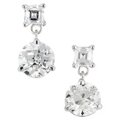 Dangle diamond earrings. Two Old European round diamonds totaling 1.29cts set in 14k white gold 3 prong settings each accented with a square step cut diamond. The stones are circa 1920's that were fashioned into classic dangle earrings that were designed and crafted in the Peter Suchy Workshop. 2 round old European cut diamonds, K/J VS SXI2 approx. 1.29cts 2 square step cut diamonds, H-I VS approx. .25cts 14k white gold Stamped: 14k 2.0 grams Top to bottom: 11.7mm or .46 Inches Width: 5.9mm or . Luxury White Asscher Cut Earrings, White Asscher Cut Diamond Earrings, Elegant Asscher Cut Diamond Earrings, White Asscher Cut Wedding Earrings, White Asscher Cut Earrings For Wedding, Luxury Silver Asscher Cut Diamond Earrings, Silver Asscher Cut Diamond Earrings Fine Jewelry, Silver Asscher Cut Diamond Earrings, Elegant Radiant Cut Diamond Earrings