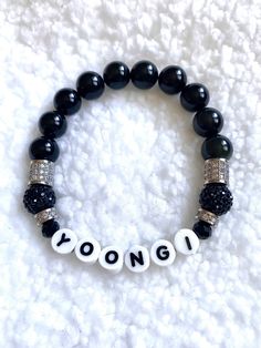 "Represent for Suga- or as we like to call him: Yoongi! BTS Yoongi Genuine Obsidian gemstone beaded bracelet in black to represent his mic color, with black and silver pavé accents. Letters are printed porcelain- NO PLASTIC. *Size can vary from 1/8\" to 1/4\" depending on bead type/size." Black Spiritual Jewelry With Letter Beads, Trendy Black Beaded Bracelets With Letter Beads, Black Kpop Jewelry For Gift, Personalized Black Jewelry For Streetwear, Black Kpop Jewelry Gift, Trendy Black Jewelry With Letter Beads, Adjustable Black Beaded Bracelets Kpop Style, Black Personalized Kpop Jewelry, Personalized Black Kpop Jewelry