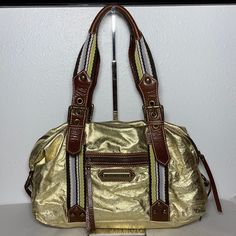 New With Tag, Some Tarnishing On Rivets. Style Is Called Fast Lane Sondra Bag. Gold Foil With Olive Lining. Exterior Front Has One Zippered Pocket, Back Has Pocket With Magnetic Flap. Interior Has Four Pockets And One Is Zippered. Dust Bag Included. 14”L X 5”W X 8.5”H (17”H With Handle) Bago, Rivets, Gold Foil, Foil, Dust Bag, Bag Lady, Exterior, Shoulder Bag, Women Shopping