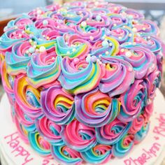 a birthday cake decorated with colorful icing and sprinkles