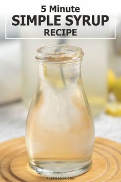 a glass jar filled with liquid sitting on top of a wooden board