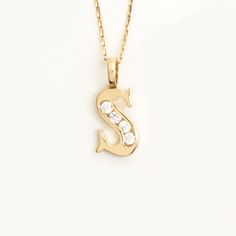 Add a touch of brilliance to your style with our Custom CZ Initial Pendant in 14K Gold. This exquisite piece showcases your chosen initial in dazzling cubic zirconia stones, set in a lustrous 14K gold pendant. Complete it with your charm and elevate your look with a personalized touch of elegance and sparkle. 14k solid gold handcrafted pieces 100% ethical sourced jewelry Material: 14k Solid Gold CZ Quality:Carat Weight: 0.10 ctwColor: F-GClarity: VS2Cut: Excellent Pendant Height: 20 mm / 0.79 in Cubic Zirconia Initial Pendant Necklace, Gold Initial Necklace In Cubic Zirconia, Elegant Yellow Gold Initial Necklace With Cubic Zirconia, Yellow Gold Initial Necklace With Cubic Zirconia, Elegant 14k Gold Initial Necklace With Diamond Accents, Gift Cubic Zirconia Diamond Necklace With Initial Pendant, Personalized Diamond Initial Necklace In Yellow Gold, Yellow Gold Cubic Zirconia Initial Pendant Necklace, Yellow Gold Cubic Zirconia Initial Necklace